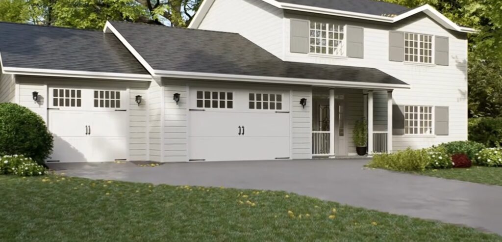 Two white carriage-style garage doors with window inserts on a two-story home with gray shutters